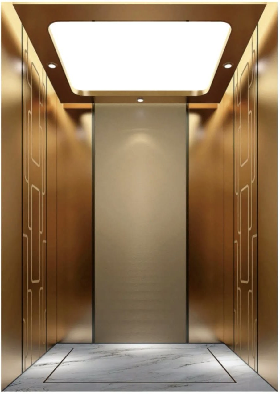 Interior of a passenger lift cabin with bronze-toned walls, etched panels and a backlit ceiling